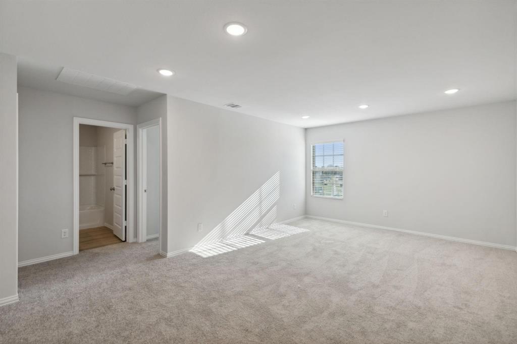 1907 Rolling Rdg Drive Van Alstyne, TX 75495 - Photo 13 of 36 Spare room featuring light carpet, baseboards, and recessed lighting