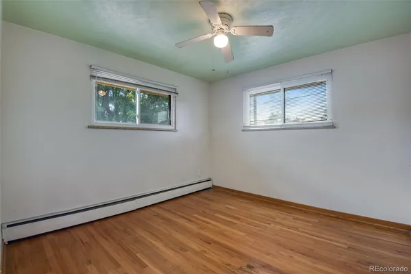 a view of empty room with wooden floor