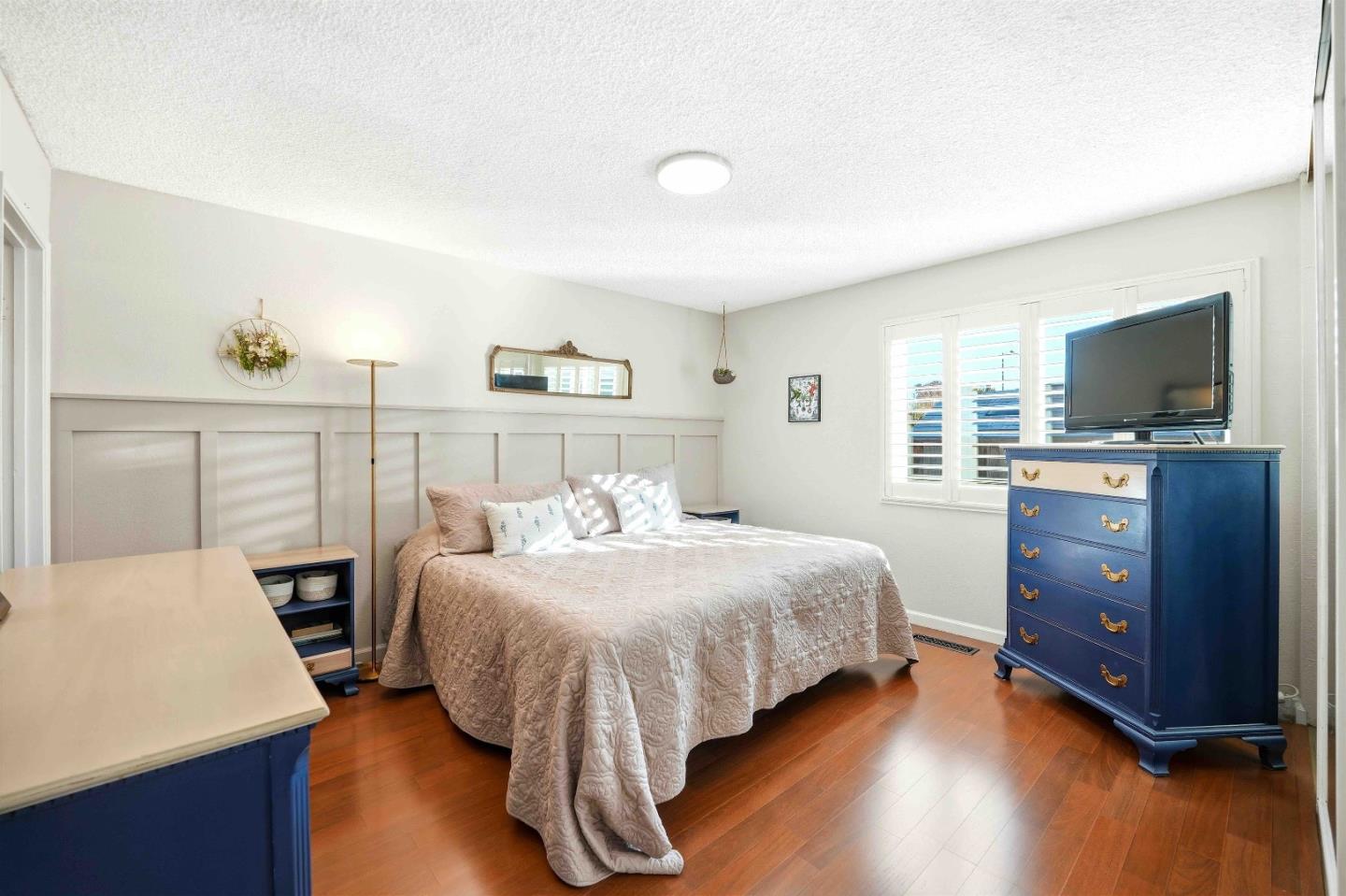 925 Blake Court Gilroy, CA 95020 - Photo 14 of 30 a bedroom with a bed and a flat screen tv