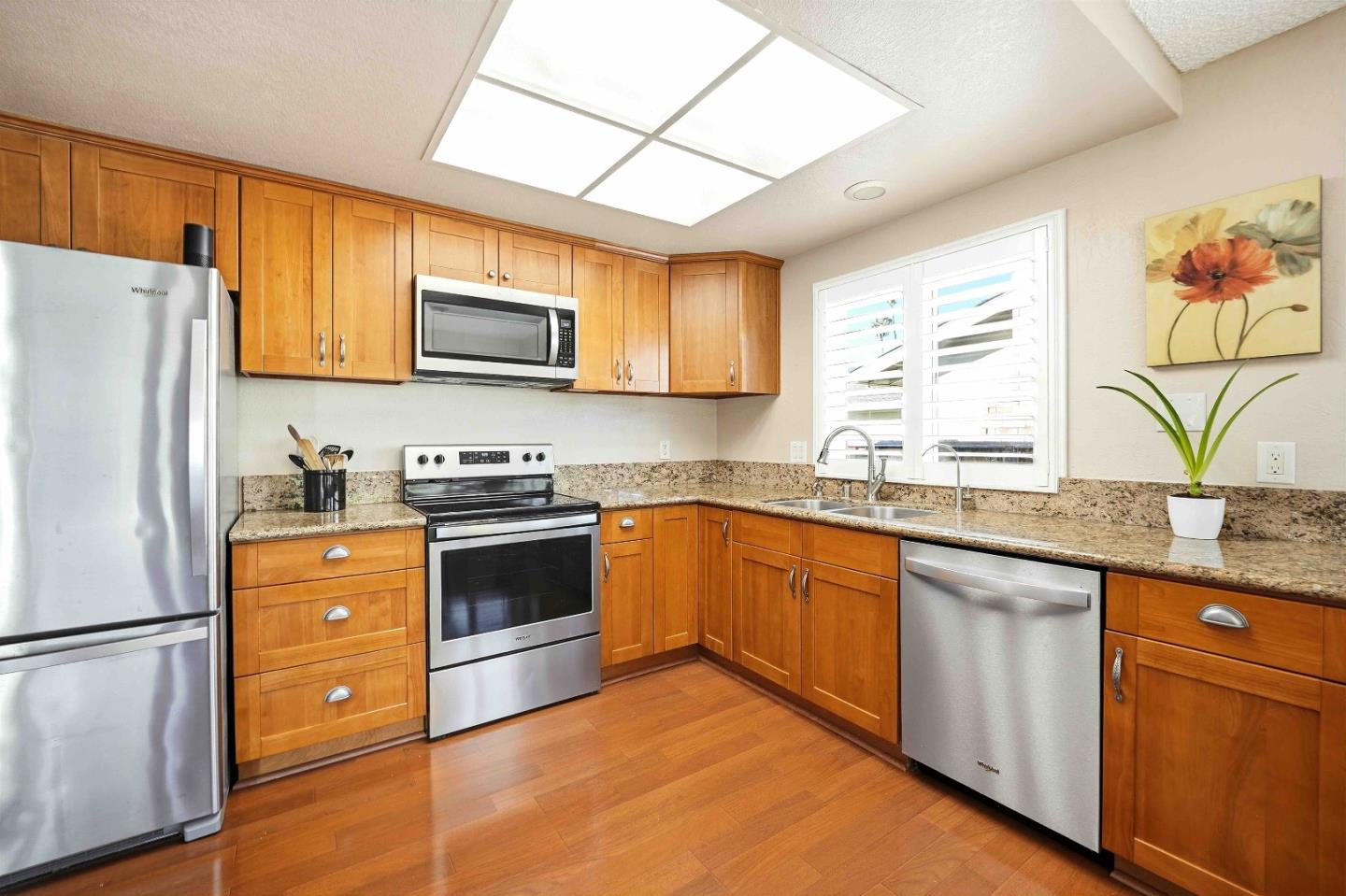 925 Blake Court Gilroy, CA 95020 - Photo 9 of 30 a kitchen with stainless steel appliances granite countertop a refrigerator a stove top oven a sink and dishwasher