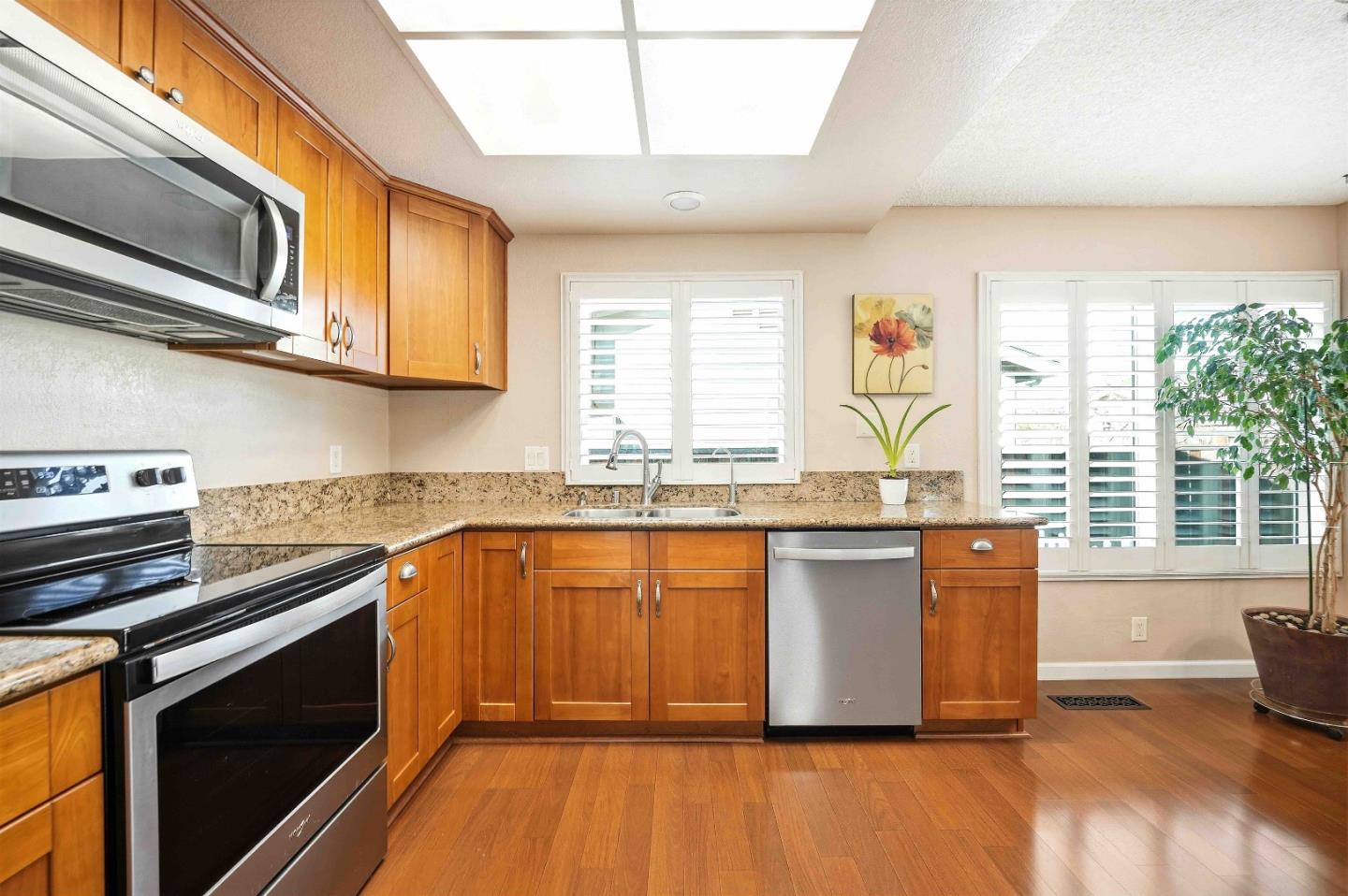 925 Blake Court Gilroy, CA 95020 - Photo 10 of 30 a kitchen with stainless steel appliances granite countertop a stove a sink and a microwave
