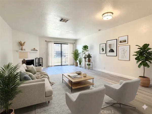 a living room with furniture and a potted plant