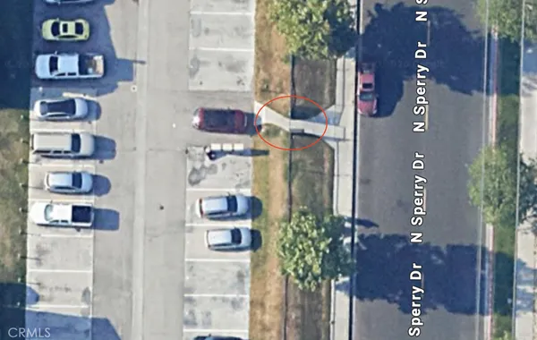 a view of a kitchen with a sink and wooden floor