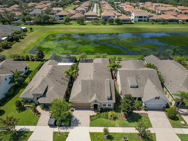 an aerial view of a house with a yard