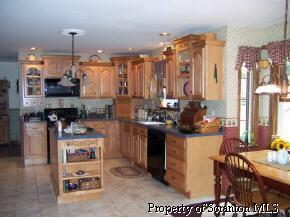 6 Callapoose Road Sterling, PA 18463 - Photo 3 of 6 a kitchen with stainless steel appliances kitchen island granite countertop a stove a sink and a refrigerator