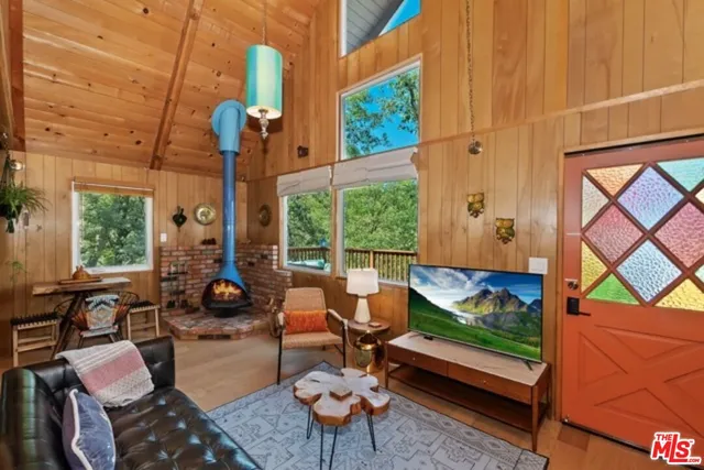 a living room with furniture and a floor to ceiling window