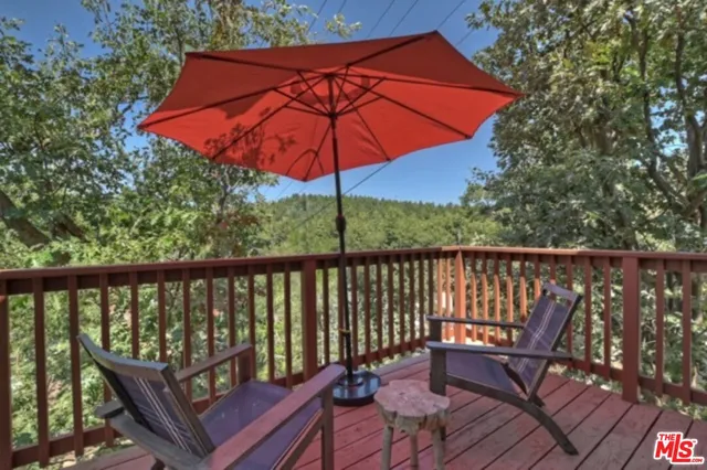a view of a deck with furniture and wooden deck