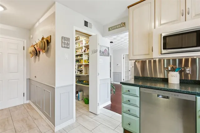 a kitchen with granite countertop a refrigerator and a sink