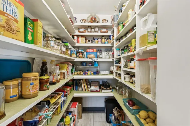 a room with lots of books and a wooden floor
