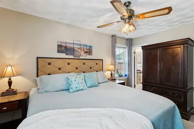 a bedroom with a large bed and a chandelier