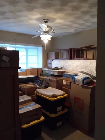 a living room with stainless steel appliances kitchen island granite countertop furniture and a fireplace