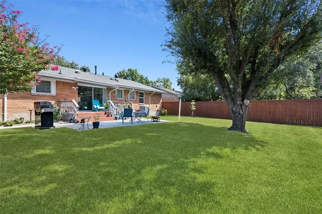 a front view of house with yard and outdoor seating