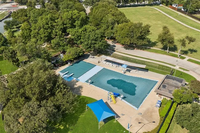 an aerial view of a house with a yard and trees