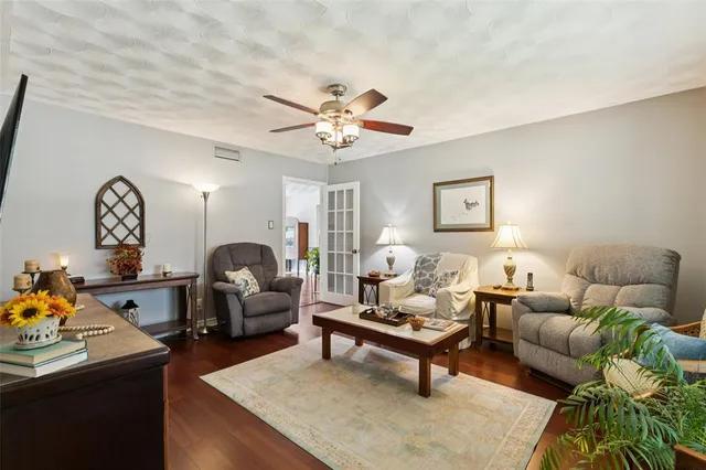 a living room with furniture a chandelier and a window