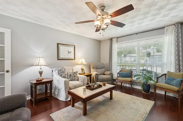 a living room with furniture a table and a large window