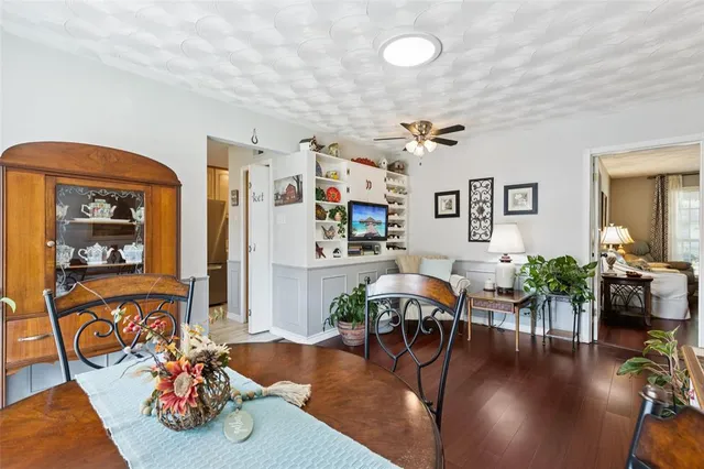 a living room with furniture dining table and wooden floor