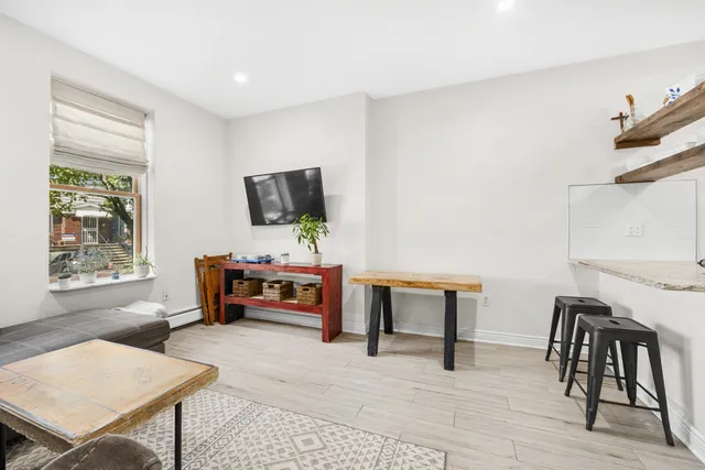a bedroom with furniture and a window