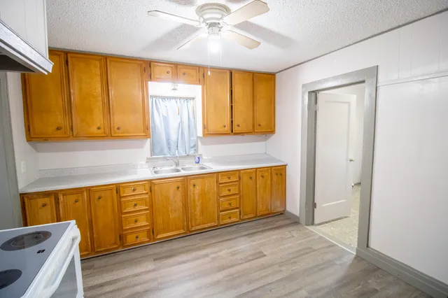 a view of a kitchen with wooden floor and cabinet