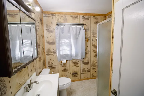 a bathroom with a shower curtain and a sink
