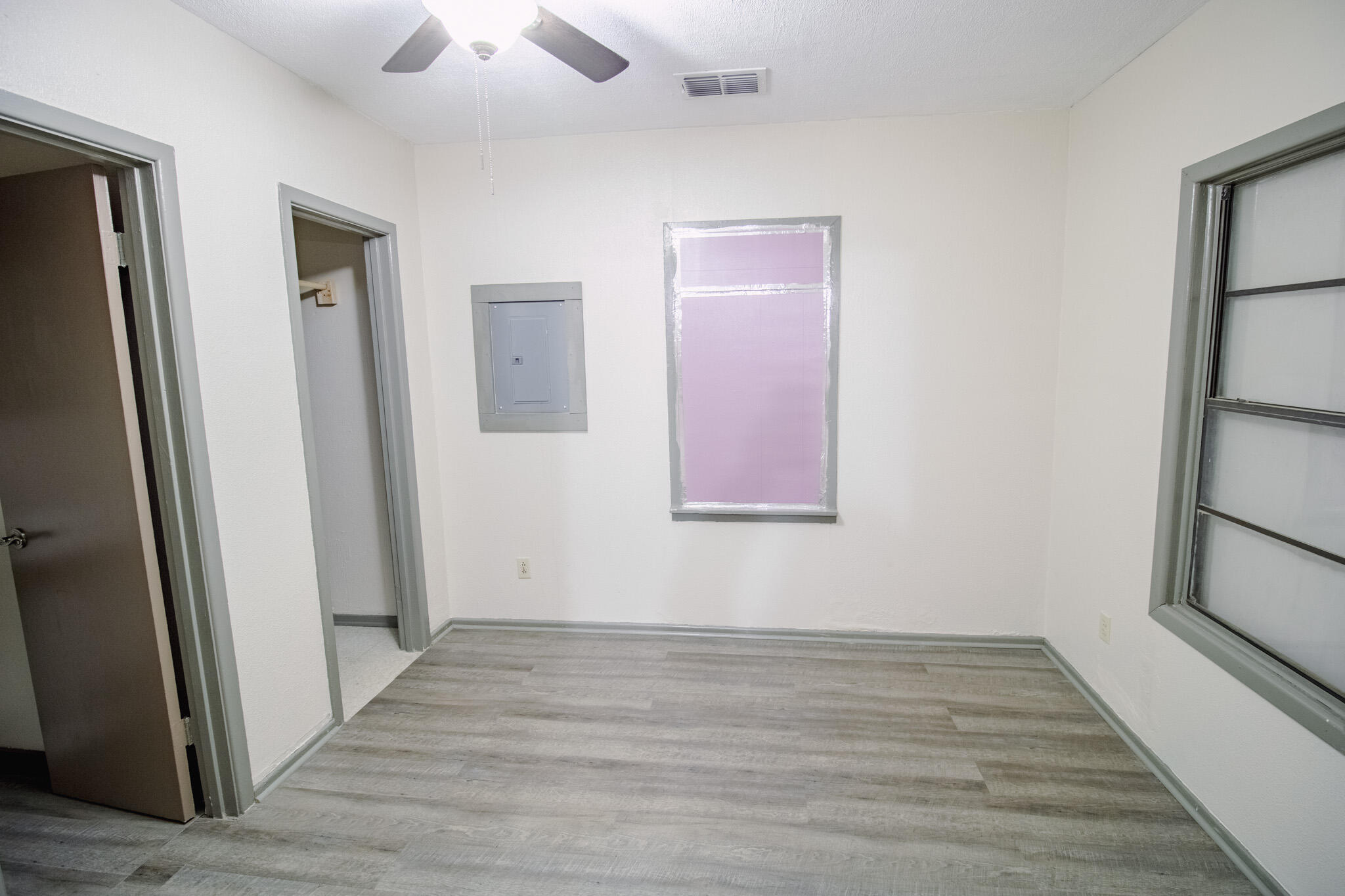3114 Baylor Street Lubbock, TX 79415 - Photo 9 of 11 a view of an empty room with wooden floor and a window