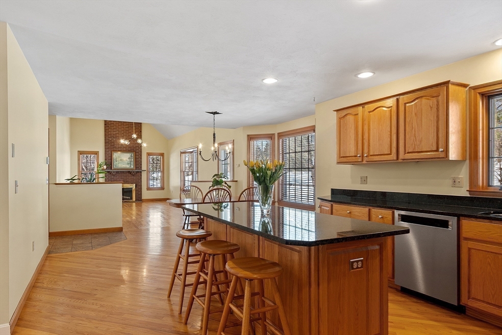 220 Hayden Road Groton, MA 01450 - Photo 11 of 37 a kitchen with stainless steel appliances granite countertop wooden cabinets a stove top oven a sink and dishwasher