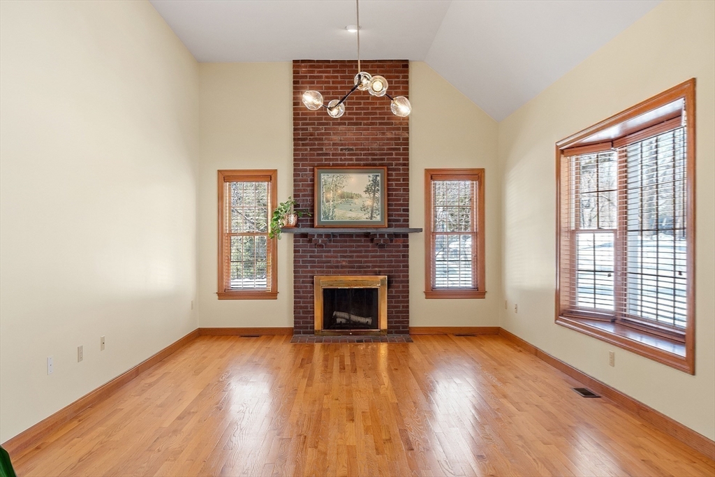220 Hayden Road Groton, MA 01450 - Photo 17 of 37 a view of an empty room with wooden floor fireplace and a window