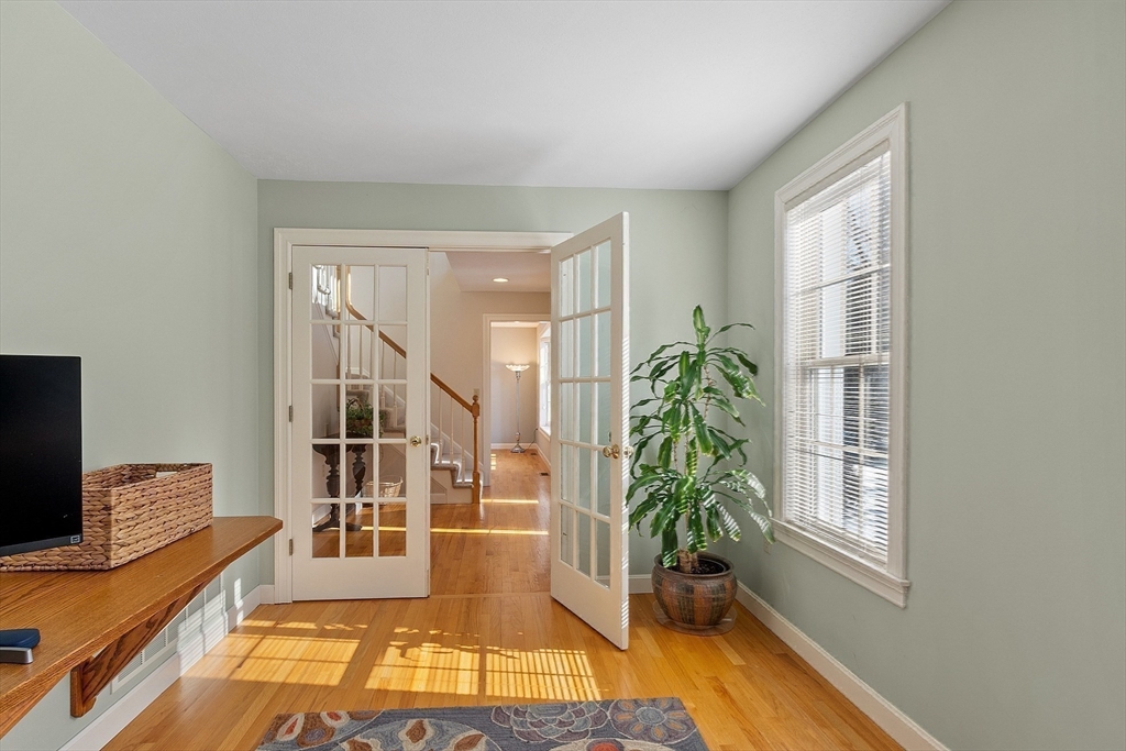 220 Hayden Road Groton, MA 01450 - Photo 18 of 37 a living room with furniture floor to ceiling window and wooden floor