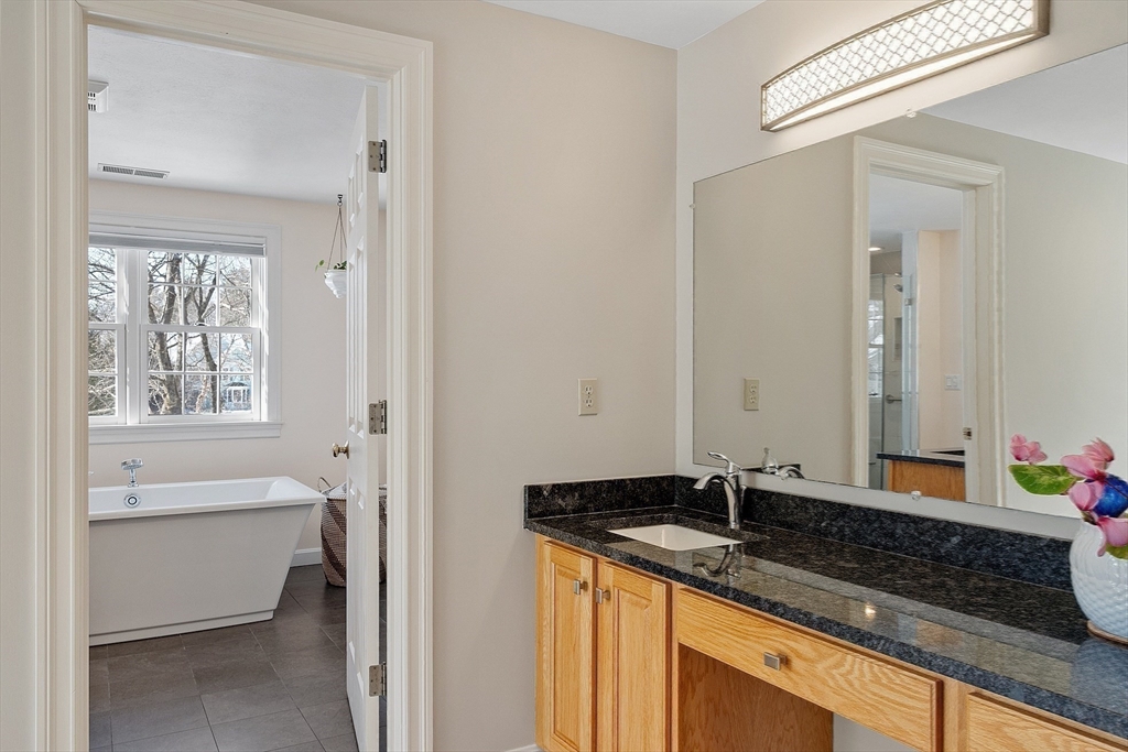 220 Hayden Road Groton, MA 01450 - Photo 24 of 37 a bath room with a sink double vanity and a mirror