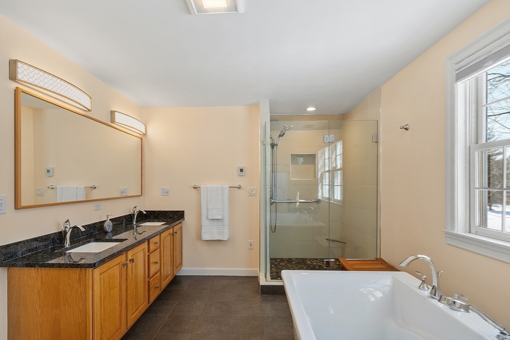 220 Hayden Road Groton, MA 01450 - Photo 25 of 37 a bathroom with a granite countertop tub sink and mirror