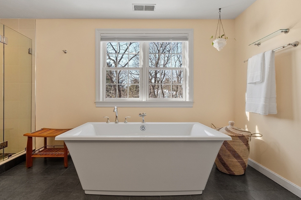 220 Hayden Road Groton, MA 01450 - Photo 26 of 37 a white bath tub sitting in a bathroom next to a window