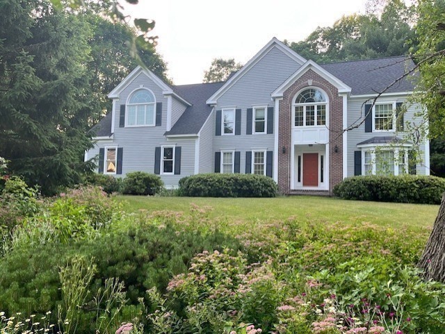 220 Hayden Road Groton, MA 01450 - Photo 3 of 37 a front view of a house with a yard and trees