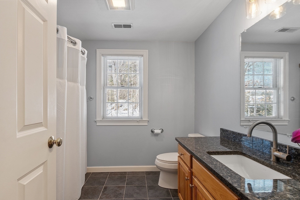 220 Hayden Road Groton, MA 01450 - Photo 32 of 37 a bathroom with a granite countertop sink toilet and shower