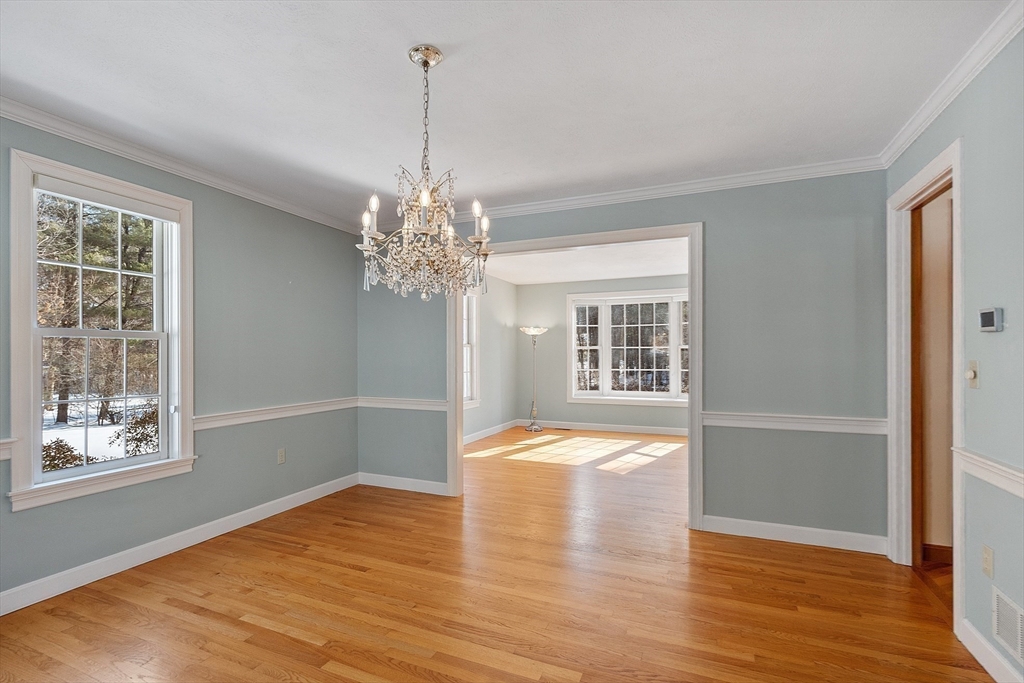 220 Hayden Road Groton, MA 01450 - Photo 8 of 37 a view of an empty room with wooden floor and a window