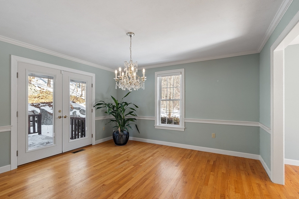 220 Hayden Road Groton, MA 01450 - Photo 10 of 37 a view of an empty room with wooden floor and a window