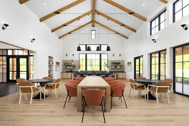 a view of a a dining room with furniture window and wooden floor