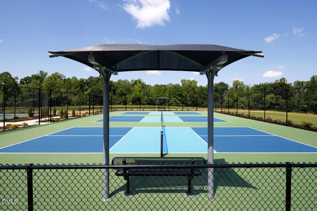 a view of a tennis court with sitting area
