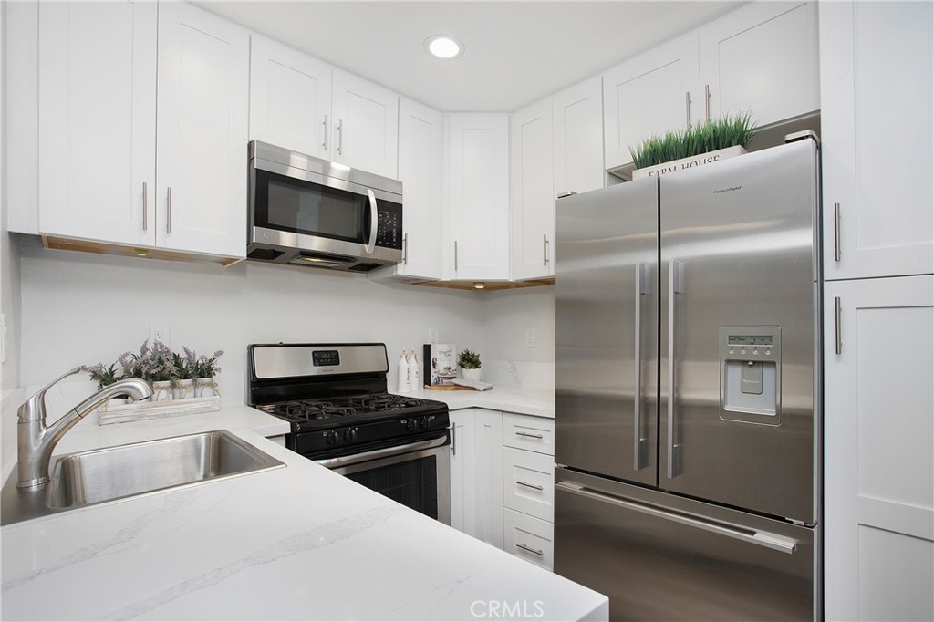 5 Rosa, Unit 140 Rancho Santa Margarita, CA 92688 - Photo 3 of 30 NEW kitchen with shaker soft close cabinetry, quartz countertops and new appliances