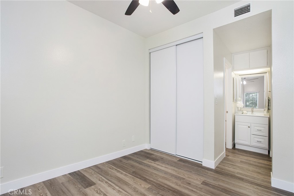 5 Rosa, Unit 140 Rancho Santa Margarita, CA 92688 - Photo 5 of 30 Primary bedroom with two closets and ceiling fan