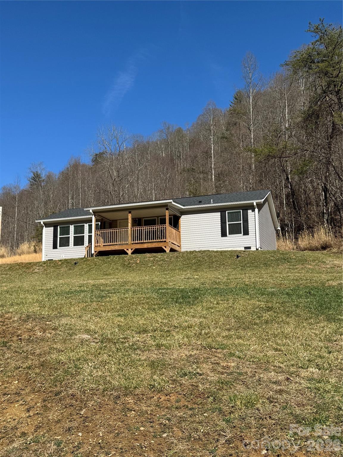 4958 Grapevine Road Marshall, NC 28753 - Photo 2 of 43 a front view of house with yard and trees in the background