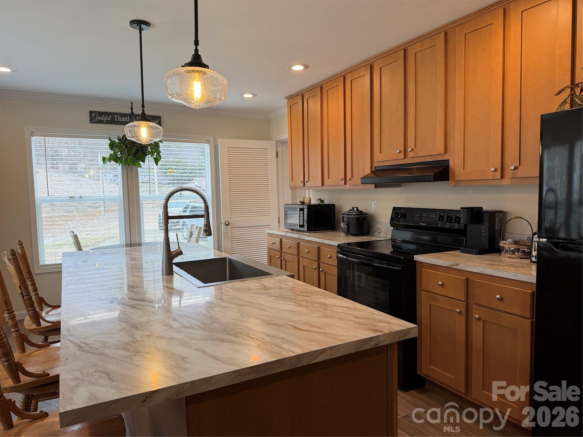 4958 Grapevine Road Marshall, NC 28753 - Photo 23 of 43 a kitchen with stainless steel appliances granite countertop a sink a stove and a refrigerator