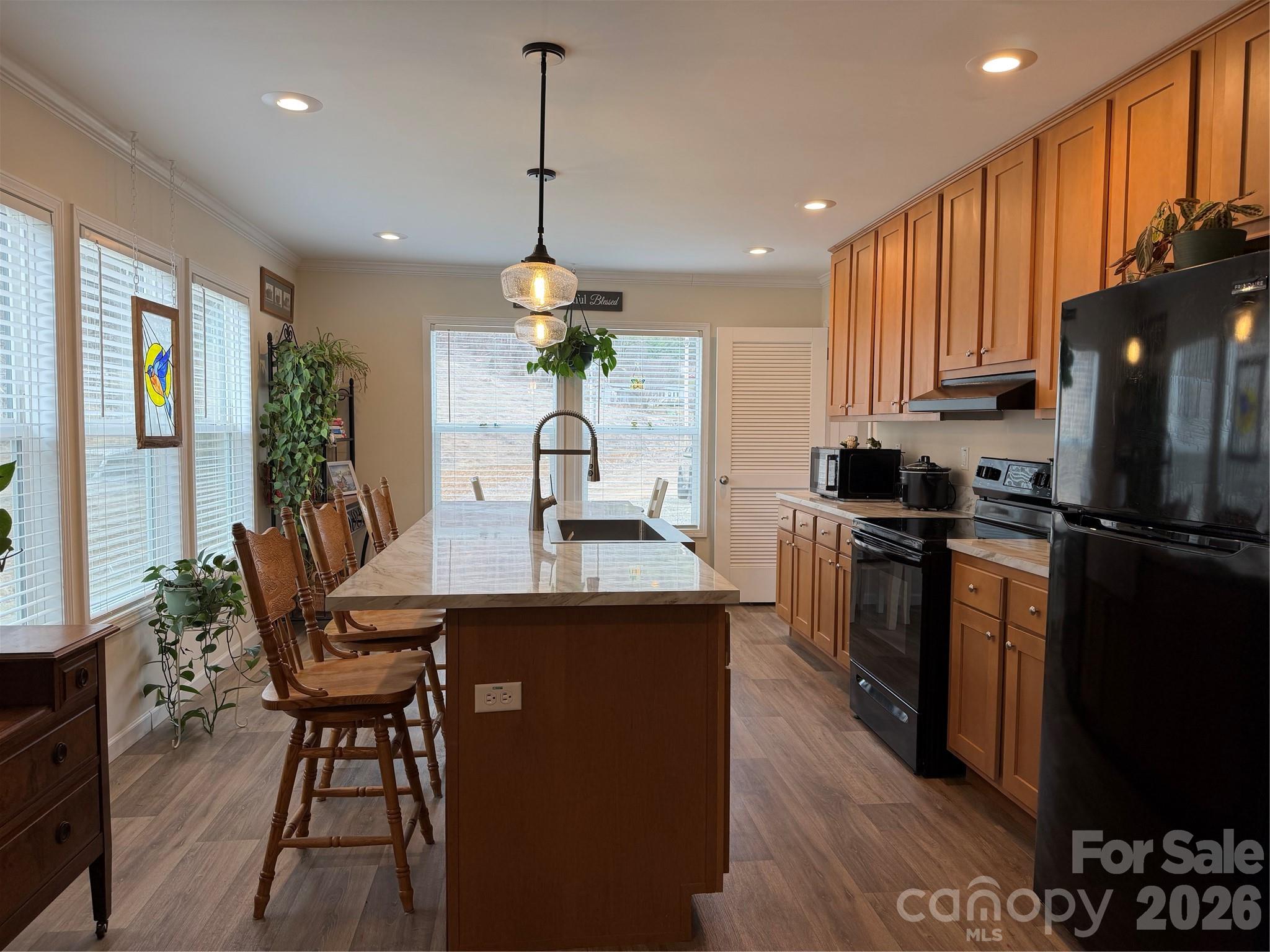 4958 Grapevine Road Marshall, NC 28753 - Photo 24 of 43 a kitchen with stainless steel appliances kitchen island granite countertop a refrigerator a stove a sink dishwasher and a dining table with wooden floor