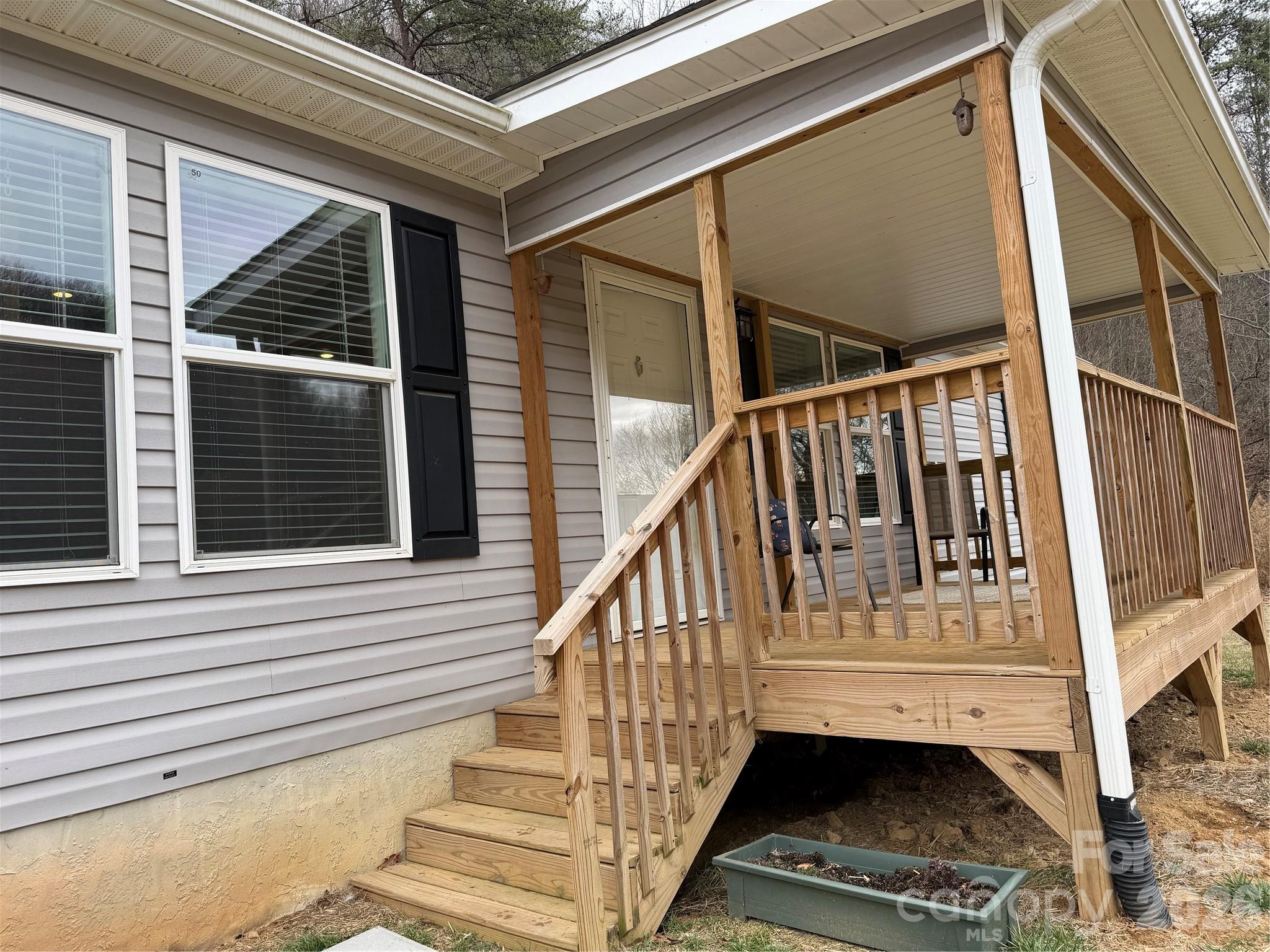 4958 Grapevine Road Marshall, NC 28753 - Photo 6 of 43 a view of entryway with wooden floor and a front door