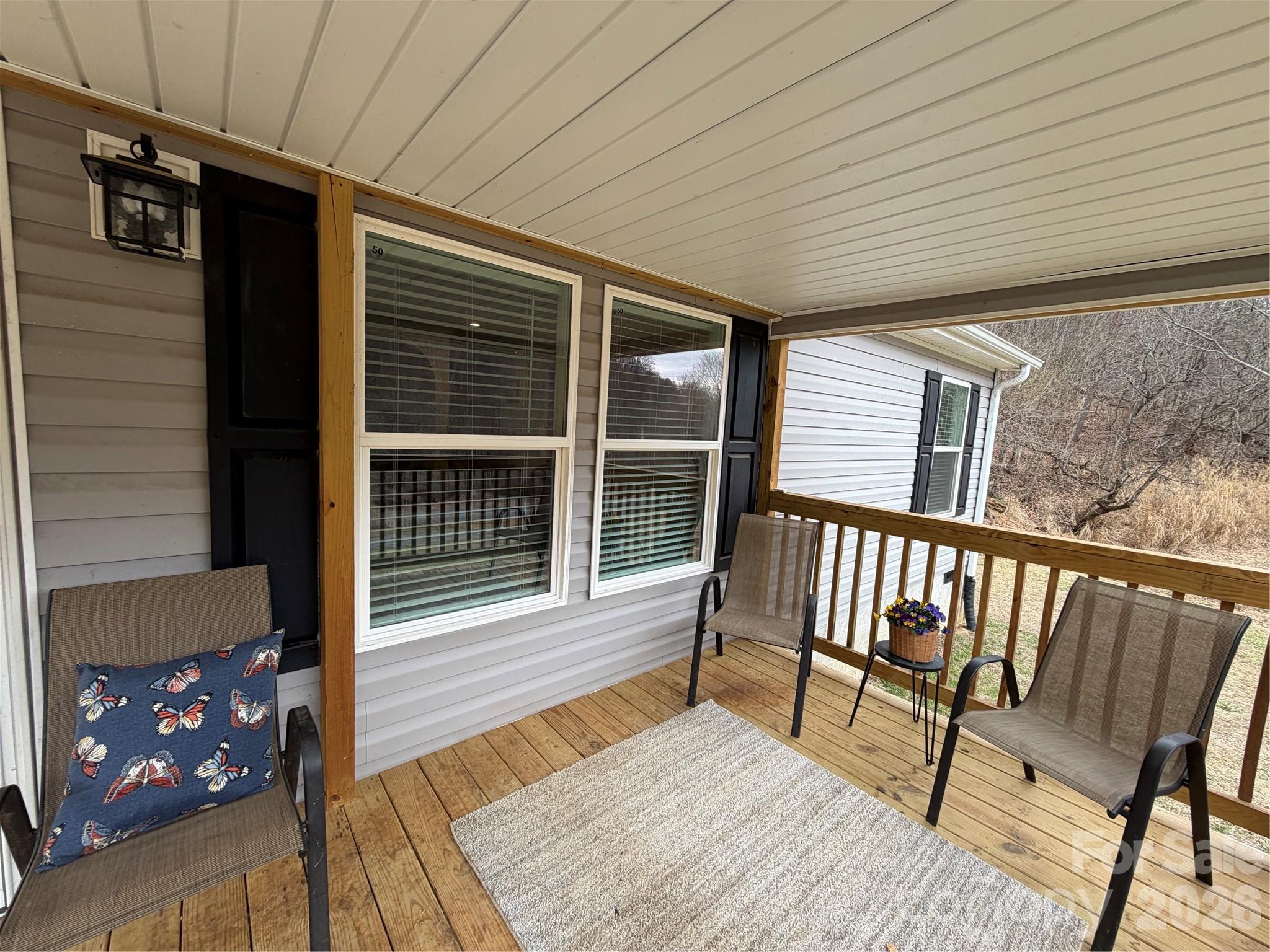 4958 Grapevine Road Marshall, NC 28753 - Photo 8 of 43 a balcony with wooden floor table and chairs