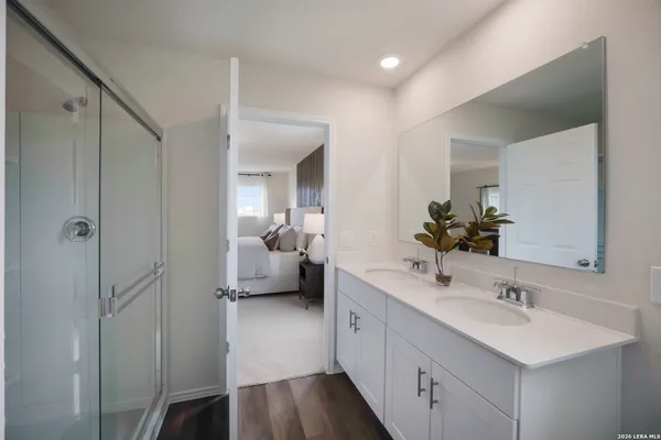 a en suite bathroom with a sink double vanity and a mirror