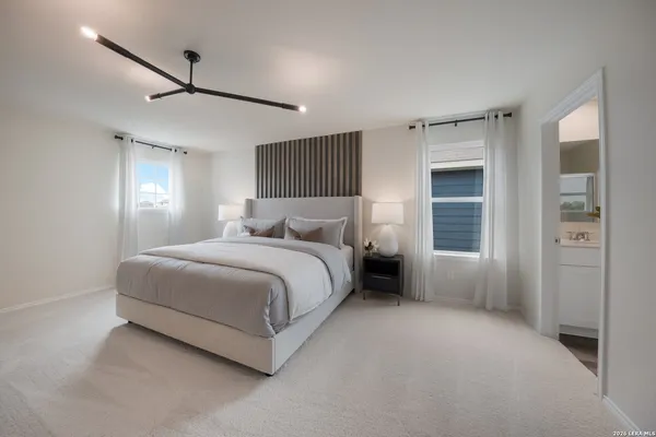 a spacious bedroom with a bed and a window
