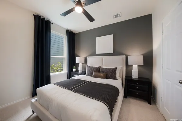 a bedroom with a bed and a night stand