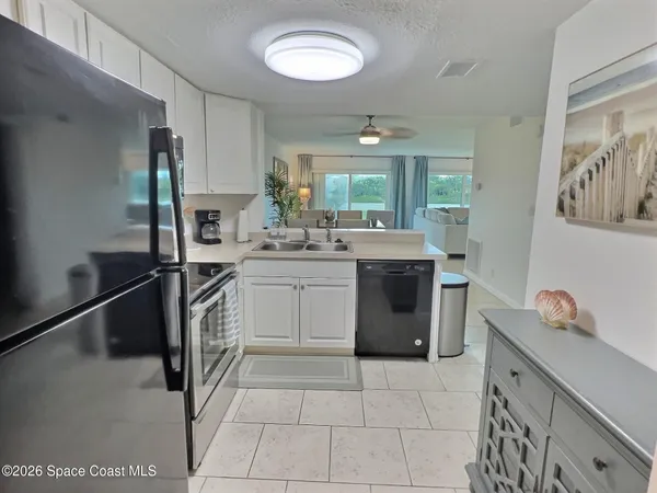 a kitchen with a stove sink and cabinets