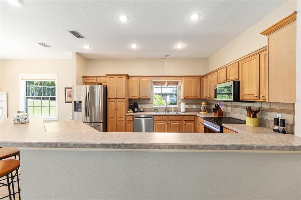 19639 Southwest 77th Loop Dunnellon, FL 34432 - Photo 28 of 59 a kitchen with stainless steel appliances granite countertop a sink and a refrigerator