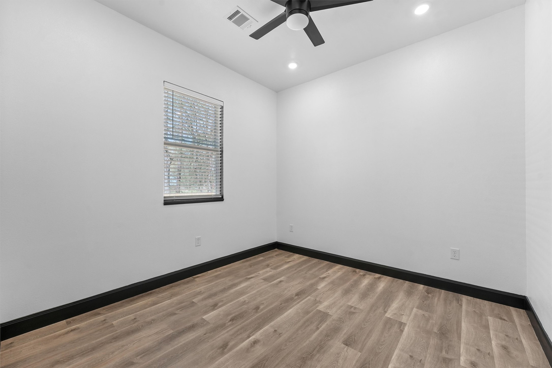 210 Canary Street Point Blank, TX 77364 - Photo 16 of 24 wooden floor in an empty room with a window