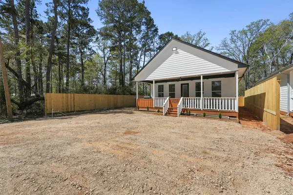 a view of a hallway with wooden floor windows and entryway